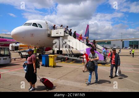 LUTON, UK - JULY 12, 2019: Passengers disembark Wizz Air Airbus A320 low coast plane at London Luton Airport in the UK. It is UK's 5th busiest airport Stock Photo