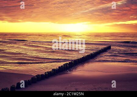 Scenic sunset over sea, Baltic Sea in Mrzezyno, color toning applied, Poland. Stock Photo