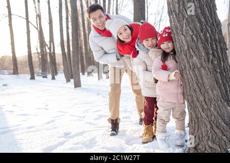 Happy family playing in the snow Stock Photo