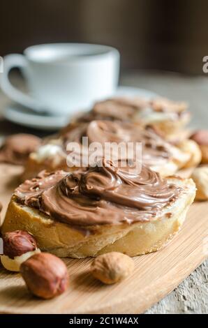 Slices of bread with chocolate cream and nuts Stock Photo