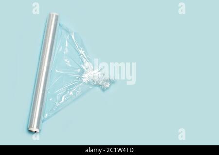 A roll of wrapping plastic stretch film on a pink background Stock Photo