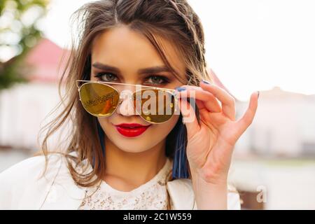 Pretty girl in sunglasses looking at camera. Stock Photo