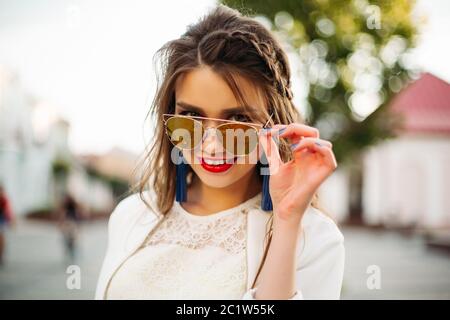 Pretty girl in sunglasses looking at camera. Stock Photo