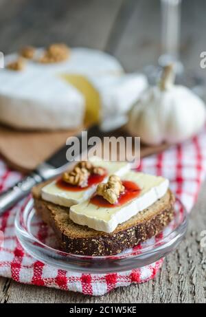 Sliced camembert on the bread Stock Photo