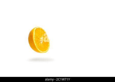 A half orange floating on a white background with shadow bellow Stock Photo