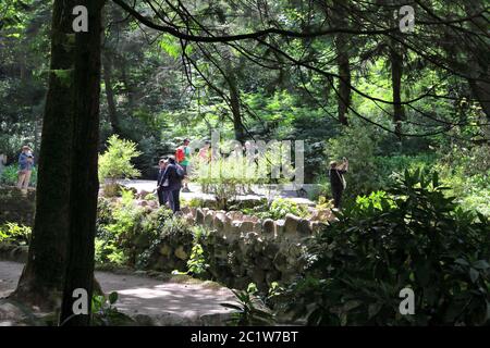 SINTRA, PORTUGAL - MAY 21, 2018: People visit Pena National Park in Sintra. Gardens of Pena Park (Jardins do Parque da Pena) are a large area of vario Stock Photo