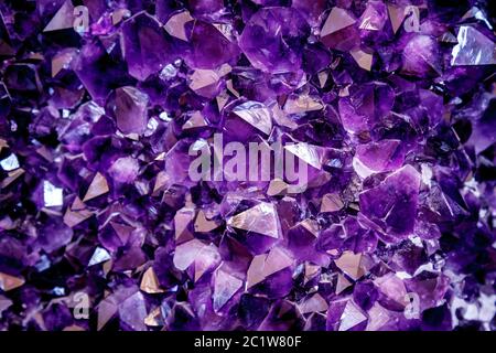 Amethyst purple crystal. Mineral crystals in the natural environment. Texture of precious and semiprecious gemstone. Stock Photo