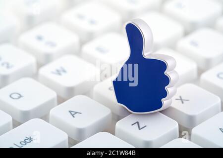 Thumb Up graphic illustration on computer keyboard Stock Photo