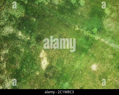 birds eye view of the ground below with a river and pathway running ...