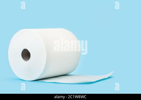 A big roll of paper towels on a blue background Stock Photo