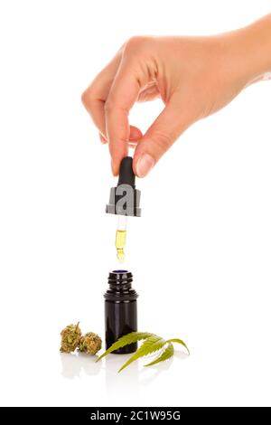Hand holding bottle of Cannabis oil in pipette Stock Photo