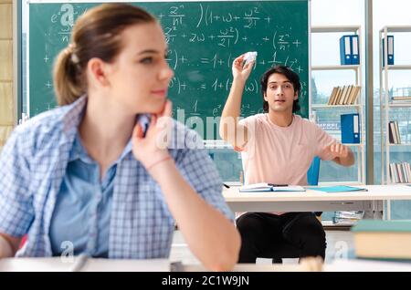 Young students taking the math exam in classroom Stock Photo