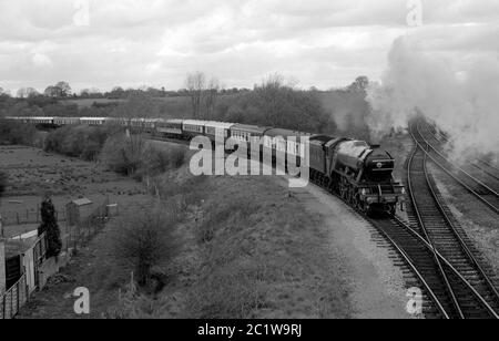 LNER A3 Class steam locomotive 'Flying Scotsman' heads The Shakespeare Limited train approaching Hatton station, Warwickshire, England, UK. 4th May 1986. Stock Photo