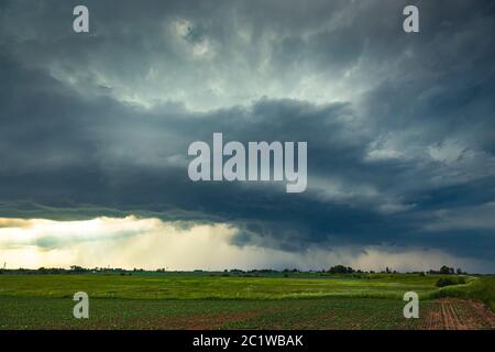 Supercell storm clouds with wall cloud and intense rain Stock Photo