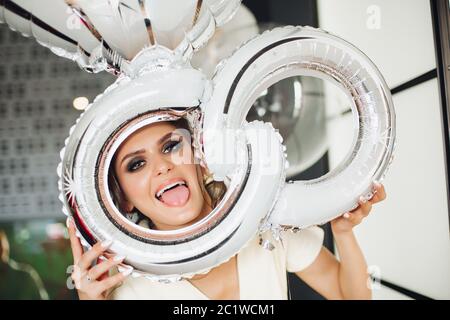 Beautiful brunette bride showing tongue at camera. Stock Photo