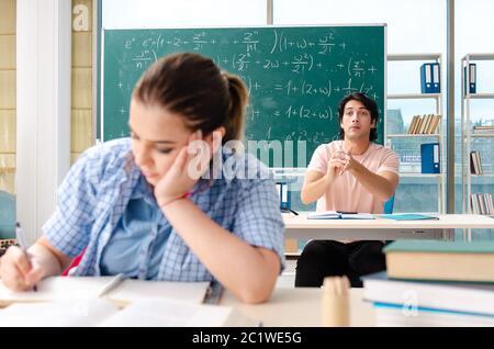Young students taking the math exam in classroom Stock Photo