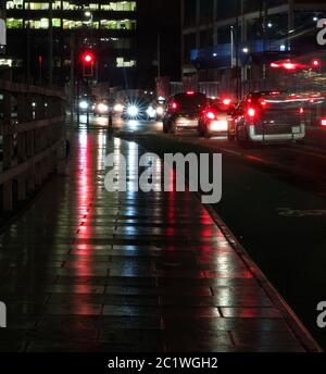 urban scene with traffic on a city street at night with motion blur from moving cars and headlights Stock Photo