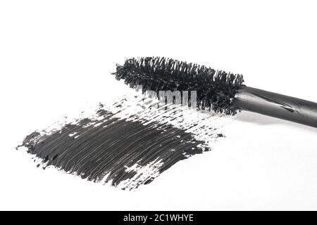 Mascara brush makes smear close-up isolated on white background Stock Photo