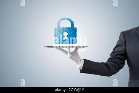 Businessman offering computer security on silver tray Stock Photo