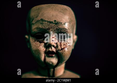 Creepy bloody doll in the dark Stock Photo