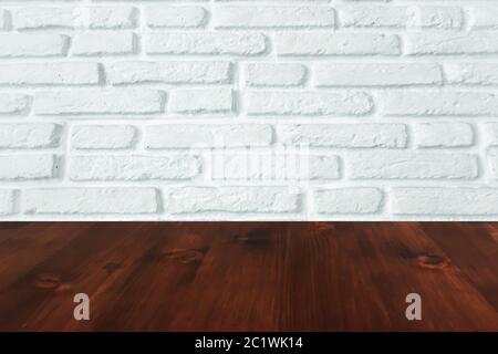 brown wood table with white brick wall texture background. Stock Photo