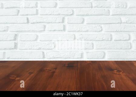 brown wood table with white brick wall texture background. Stock Photo
