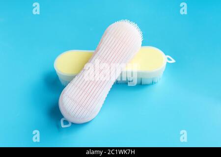 Brush for cleaning clothes on blue background. Stock Photo