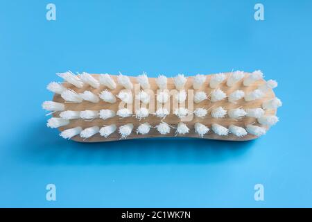 Brush for cleaning clothes on blue background. Stock Photo