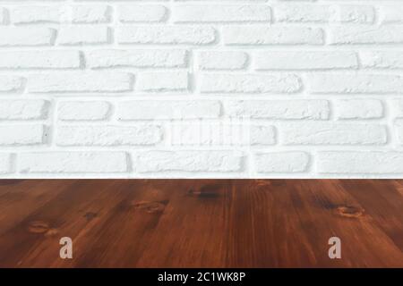 brown wood table with white brick wall texture background. Stock Photo