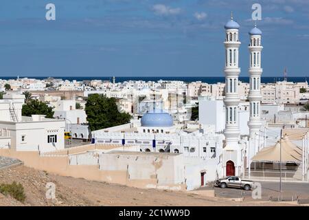 View over town of Sur in Oman towards the sea with its white buildings and minarets Stock Photo