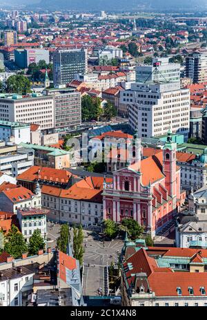 Ljubljana, Slovenia.  View from the castle down to Presernov trg (or square) and the Baroque Franciscan Church of the Annunciation. Stock Photo