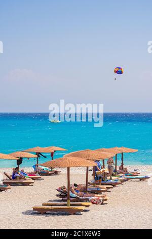 Elli Beach sun loongers with shade umbrellas, Rhodes Town, Rhodes Island, Dodecanese, Greece Stock Photo