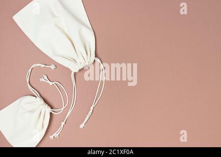 Canvas sacks with drawstrings. Plastic free concept with copy space on brown background. Stock Photo