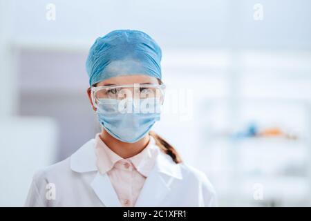 portrait of a female scientist in a protective mask. Stock Photo