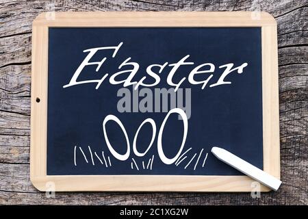 Easter and Easter eggs written and painted on a blackboard Stock Photo