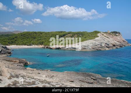 View along coastal footpath towards Cala Matzoc beach and Torre D’Aubarca medieval watchtower, Llevant Peninsula Natural Park, near Arta, Mallorca eas Stock Photo