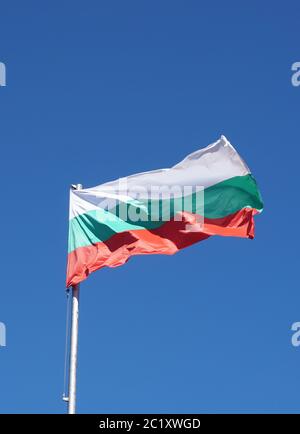 Bulgarian flag waving in the wind and sunlight, and a blue sky. Stock Photo