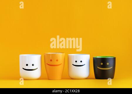 Coffee Cups with Happy Emoticons - Conceptual Image for Business Team Coffee Break with Copy Space Stock Photo