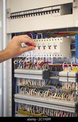 Male electrician working with equipment Stock Photo