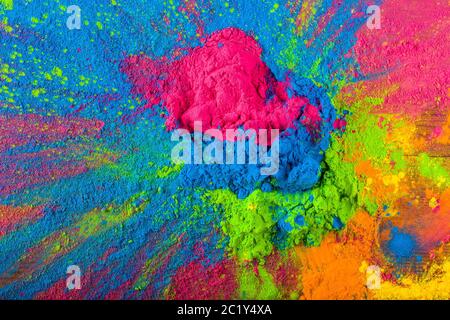 Abstract colorful Happy Holi background. Color vibrant powder on wood. Dust colored splash texture. Flat lay holi paint decorati Stock Photo