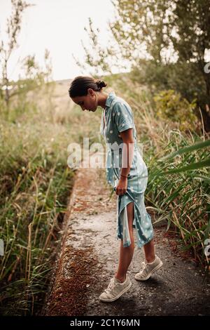 Alone woman on the forest with beautifull dress