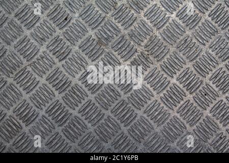 A texture of an old checker plate with dirt and rust on it. Stock Photo