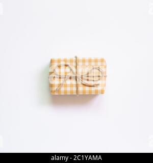 Yellow check pattern gift box isolated on white background. top view, copy space Stock Photo