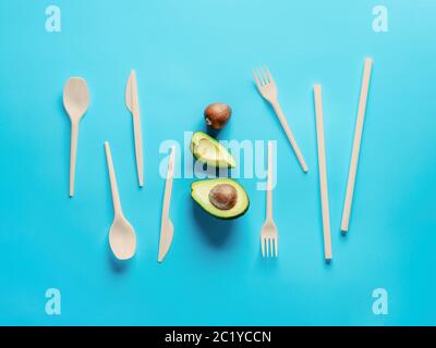 Avocado Seeds Biodegradable Single-Use Cutlery. Bioplastic - Great alternative to plastic disposable cutlery. Minimal concept on blue background. Stock Photo