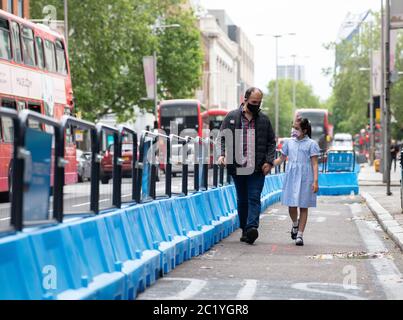 Children wearing facemasks during coronavirus pandemic.  Walking Streetspace for London, outside Waterloo station.  London, UK. June 7, 2020.    CONSE Stock Photo