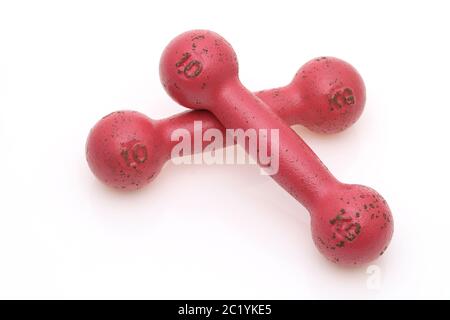 Two pink painted dumbbells fitness isolated on white background Stock Photo