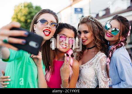 Browse Free HD Images of Woman With Bold Sunglasses Poses For The Camera