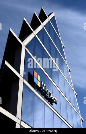 Microsoft logo company on the window facade of the new Microsoft headquarter, in Milan. Stock Photo