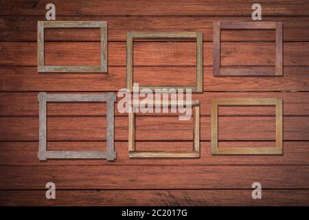 Vintage photo frames on wood wall for interior or background. Stock Photo