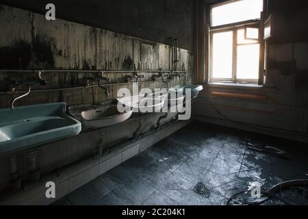 Burnt house interior. Charred walls of toilet after a fire. Stock Photo